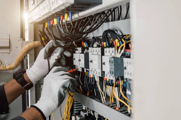 electrician engineer tests electrical installations and wires on relay protection system. - electriian photos et images de collection